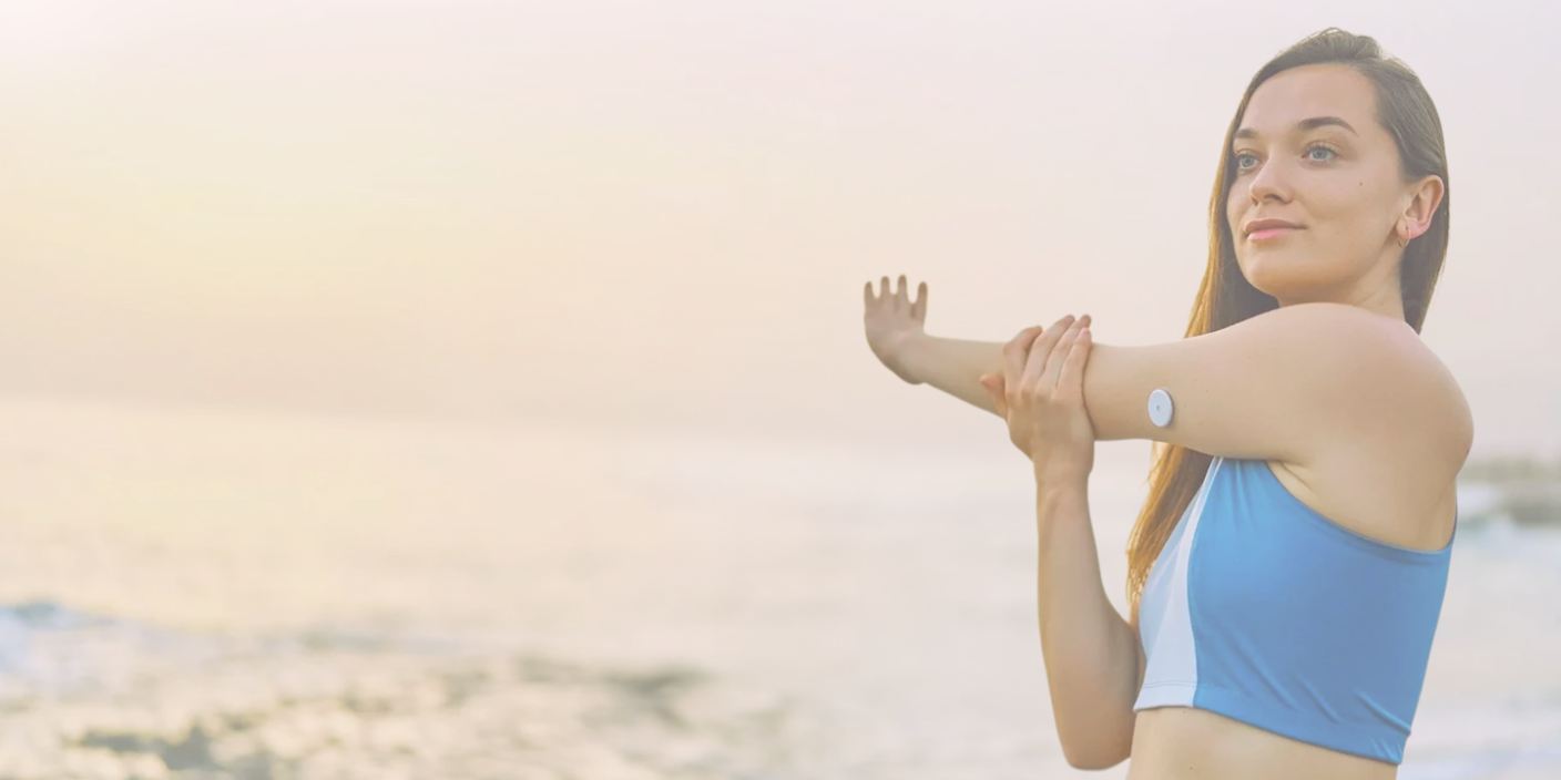 Woman exercising with CGM sensor